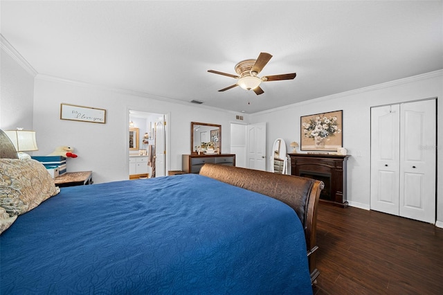 bedroom featuring connected bathroom, ceiling fan, dark hardwood / wood-style flooring, a closet, and ornamental molding