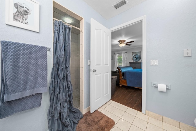 bathroom with tile patterned floors, a shower with curtain, and ceiling fan