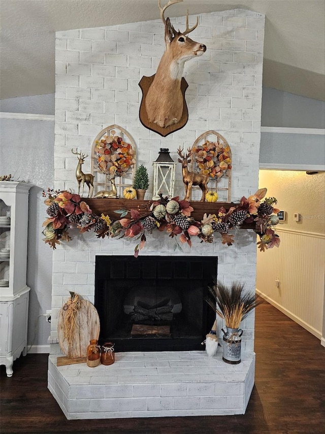 details featuring wood-type flooring and a brick fireplace