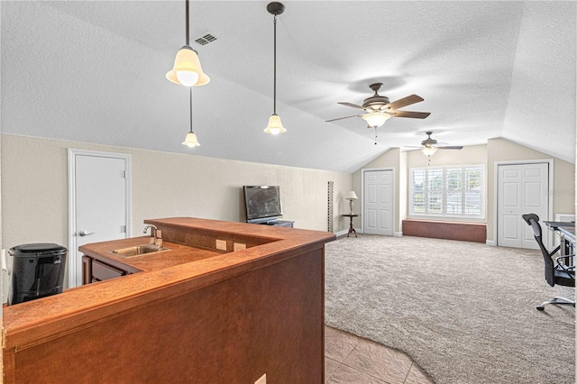 home office featuring sink, ceiling fan, a textured ceiling, light carpet, and vaulted ceiling