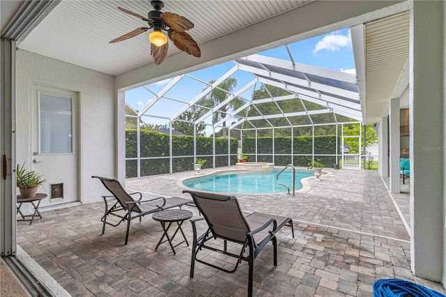 view of swimming pool with ceiling fan, a lanai, and a patio