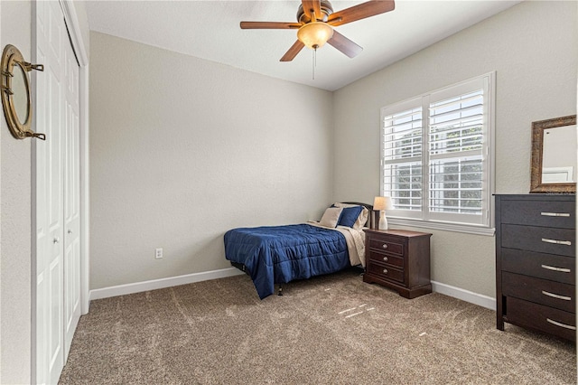 bedroom featuring ceiling fan, light colored carpet, and a closet