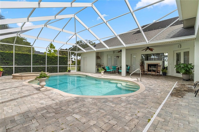 view of swimming pool featuring a patio, an in ground hot tub, ceiling fan, and glass enclosure