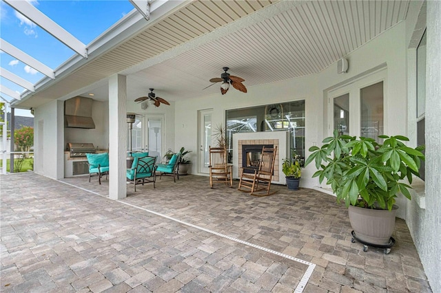 view of patio featuring area for grilling and ceiling fan