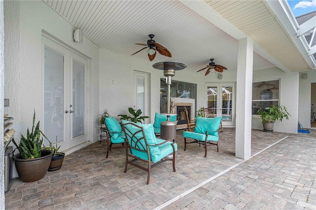 view of patio with an outdoor living space, ceiling fan, and french doors