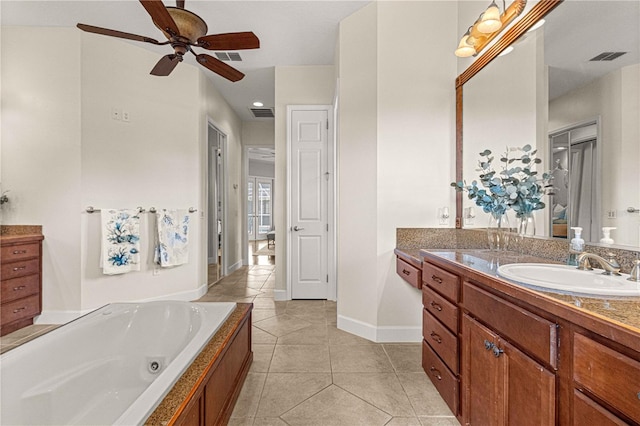 bathroom featuring tile patterned flooring, vanity, a bathing tub, and ceiling fan