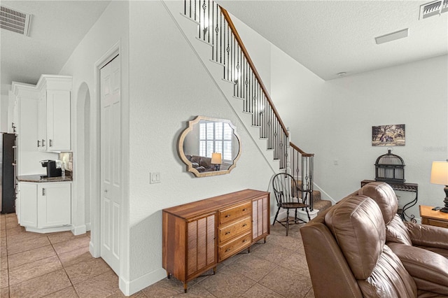 living room with light tile patterned floors and a textured ceiling