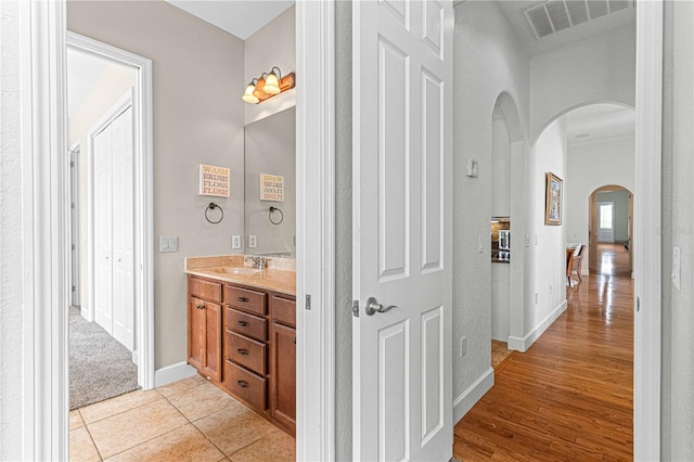 bathroom featuring tile patterned flooring and vanity