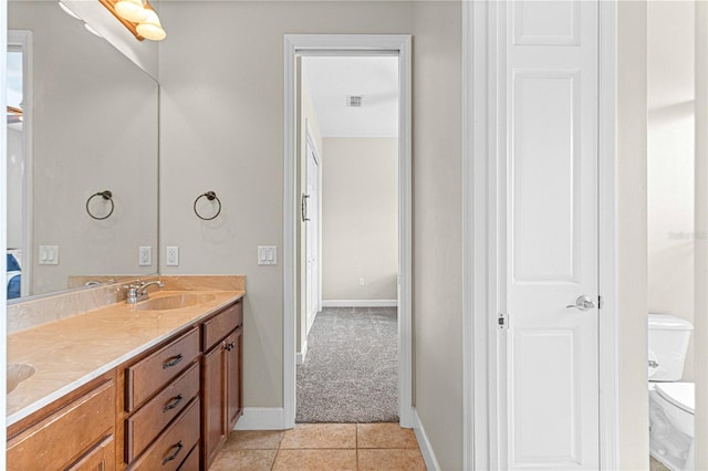 bathroom with vanity, tile patterned floors, and toilet