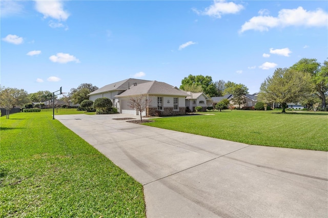 view of front facade with an attached garage, concrete driveway, and a front lawn