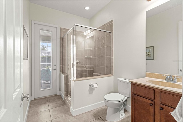 bathroom featuring tile patterned flooring, toilet, and a stall shower