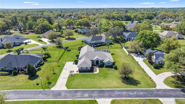 aerial view featuring a forest view and a residential view