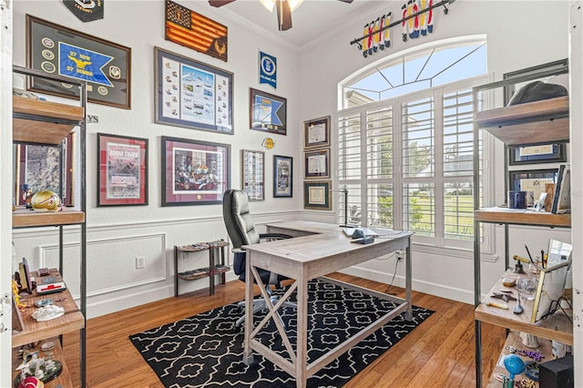 home office featuring baseboards, wood finished floors, ornamental molding, and a ceiling fan