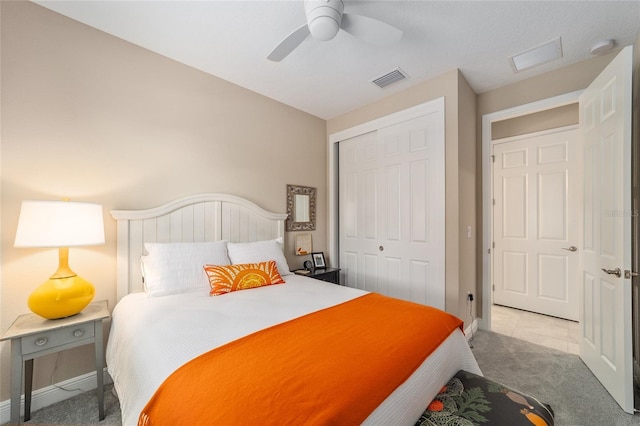 bedroom featuring ceiling fan, a closet, and light carpet