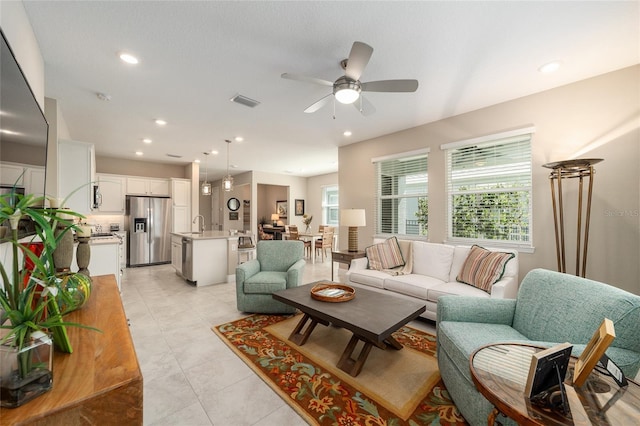 tiled living room with ceiling fan