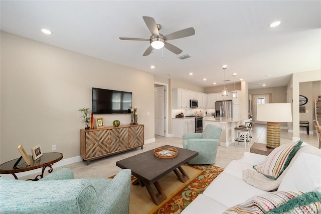 tiled living room with ceiling fan