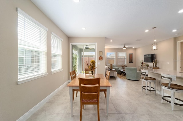 dining room with ceiling fan, light tile patterned floors, and a healthy amount of sunlight