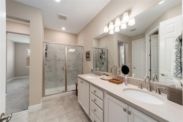 bathroom with tile patterned floors, a shower with shower door, and vanity