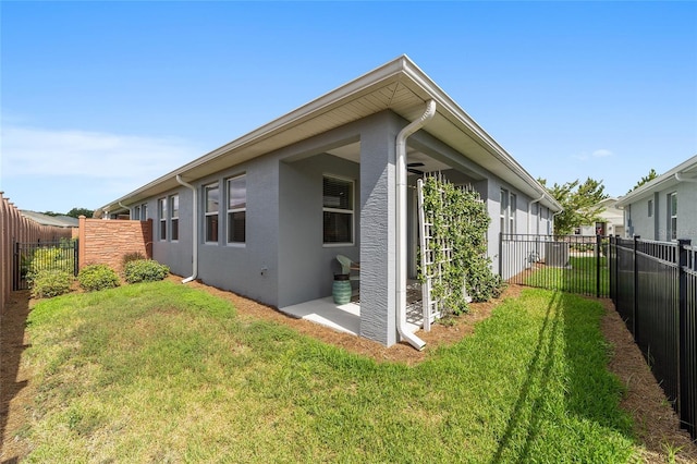 view of side of property with a yard