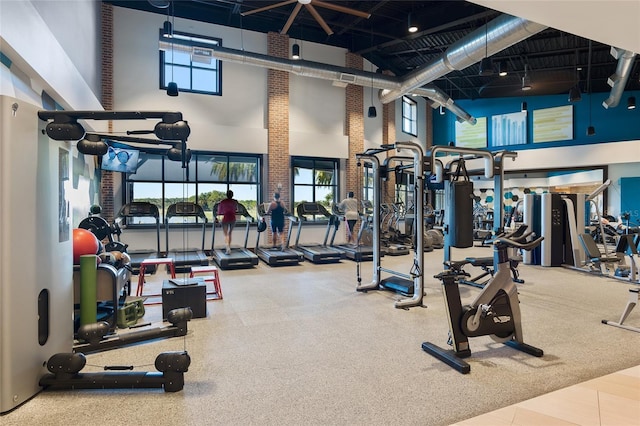 exercise room with a high ceiling