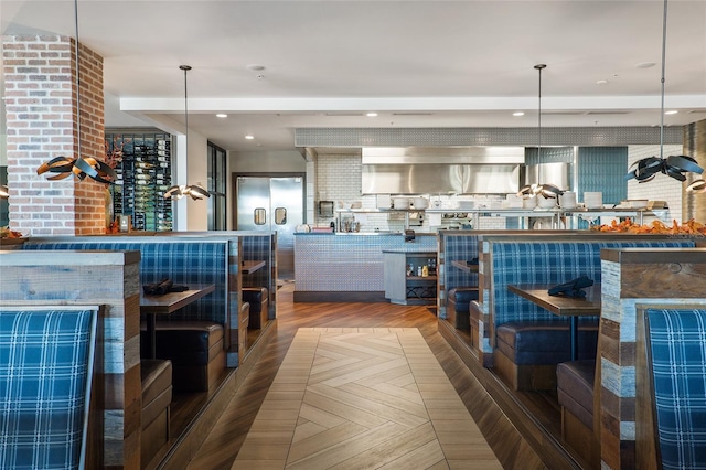 kitchen with hanging light fixtures, parquet floors, and tasteful backsplash