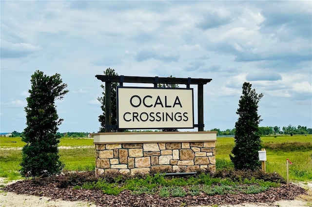 community / neighborhood sign featuring a rural view