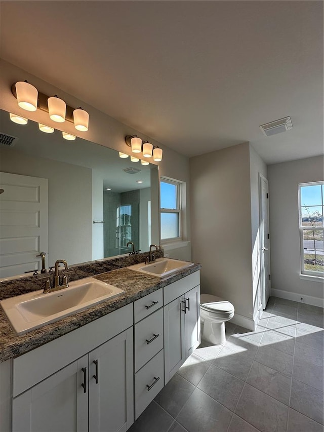 bathroom featuring tile patterned flooring, vanity, and toilet