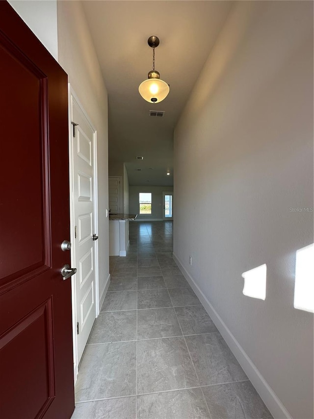 hallway featuring light tile patterned floors