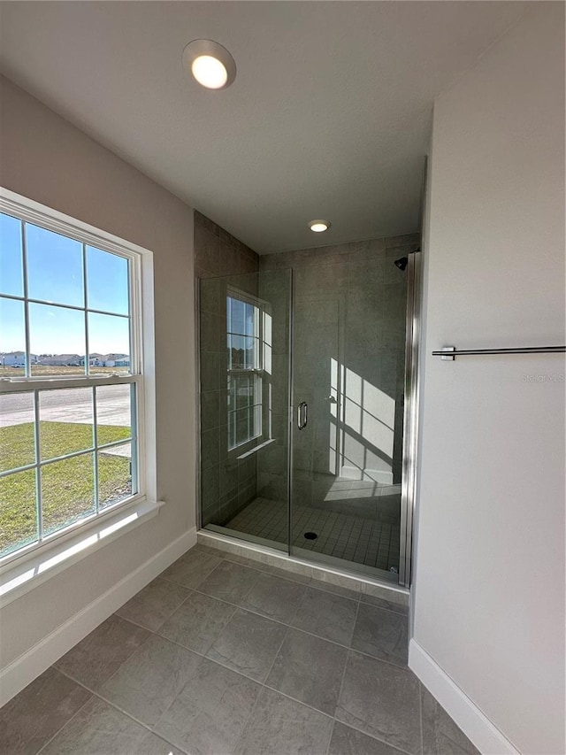 bathroom featuring tile patterned floors and a shower with door