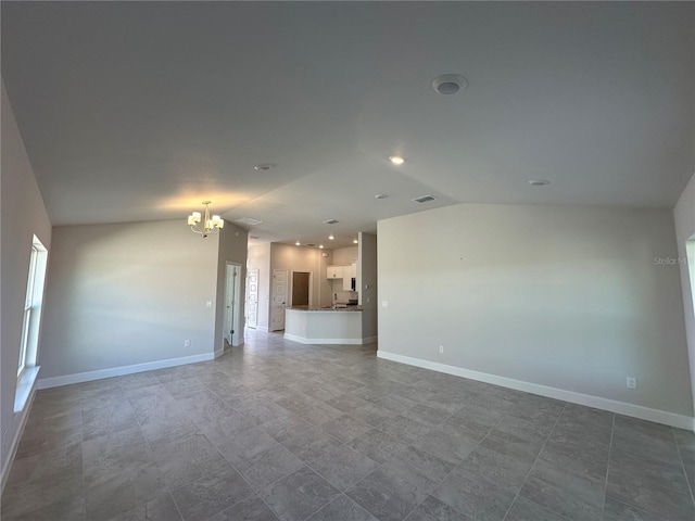 unfurnished living room with a notable chandelier and lofted ceiling