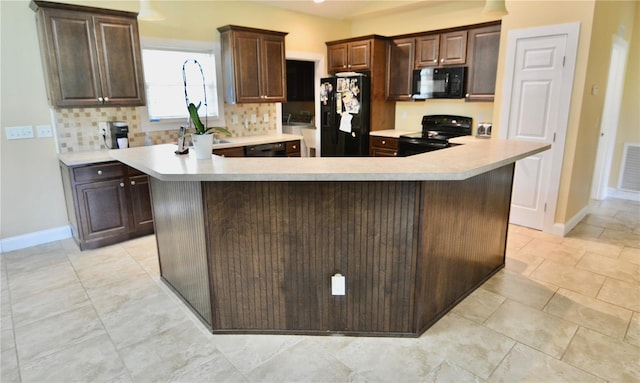 kitchen with black appliances, a center island, and tasteful backsplash