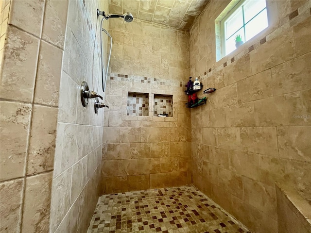 bathroom with a tile shower