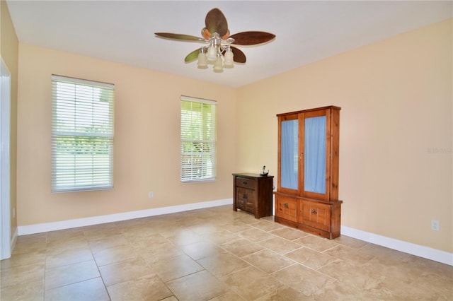 tiled empty room with ceiling fan