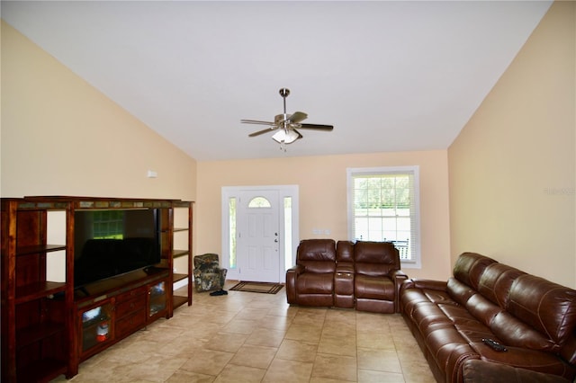 tiled living room featuring ceiling fan and lofted ceiling