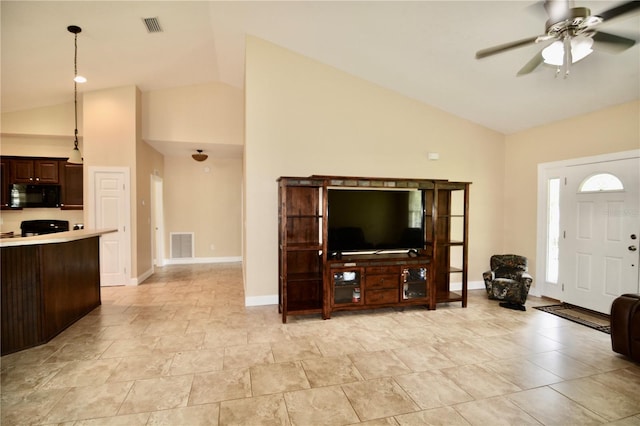 living room featuring ceiling fan and high vaulted ceiling