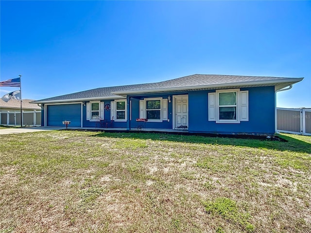 single story home with a garage and a front lawn