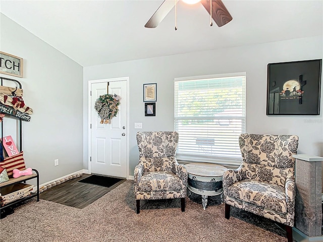 living area with vaulted ceiling, carpet floors, and ceiling fan