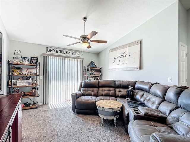 living room featuring ceiling fan, lofted ceiling, and carpet floors