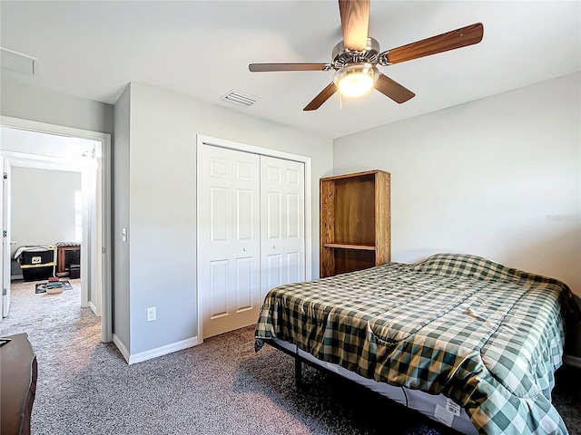 carpeted bedroom with ceiling fan and a closet