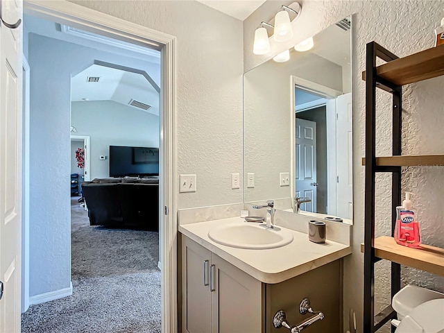 bathroom featuring vanity and vaulted ceiling