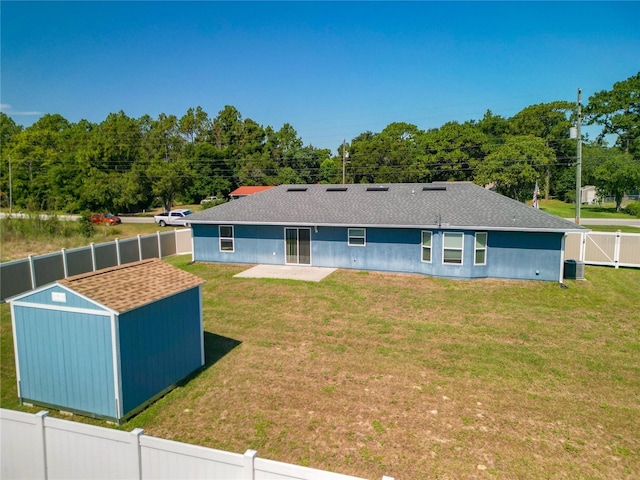 back of house featuring central AC, a patio area, and a lawn