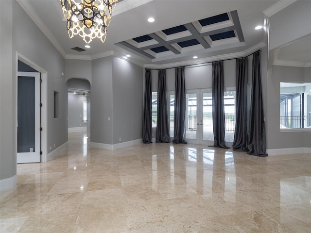 empty room featuring a notable chandelier, crown molding, a towering ceiling, and coffered ceiling