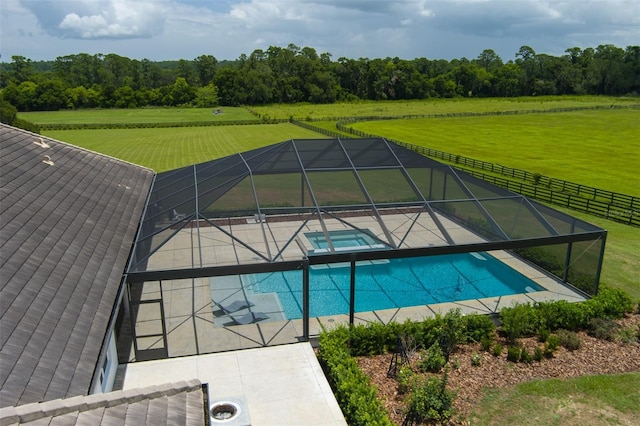 view of swimming pool featuring an in ground hot tub, a lanai, a yard, and a patio area