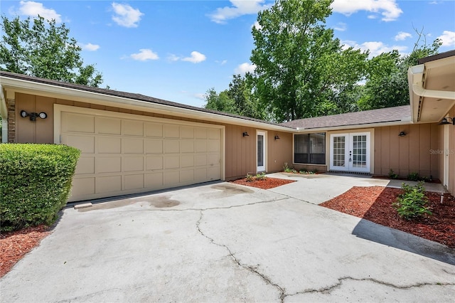 single story home featuring a garage and french doors