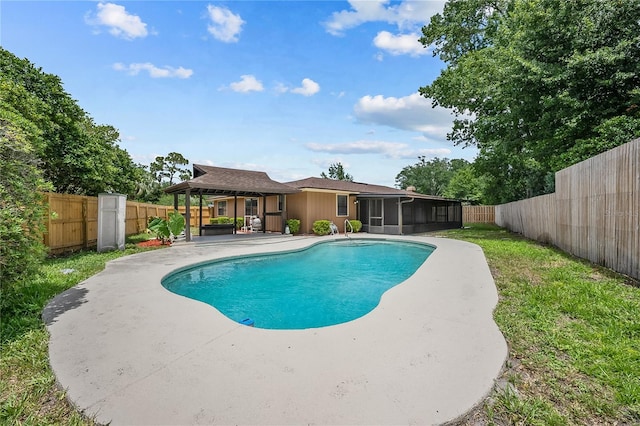 view of pool with outdoor lounge area, a gazebo, and a sunroom