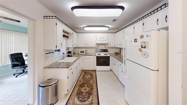 kitchen featuring a sink, white appliances, white cabinets, under cabinet range hood, and visible vents