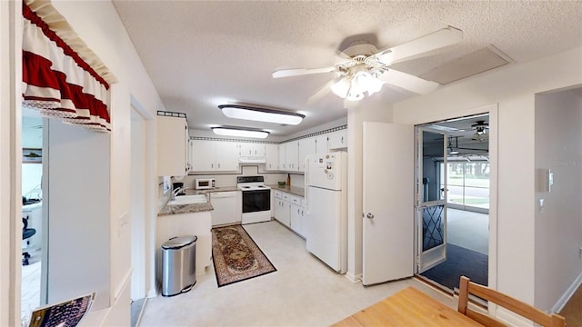 kitchen featuring a textured ceiling, white cabinetry, white appliances, ceiling fan, and light countertops