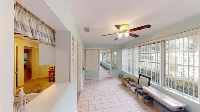unfurnished sunroom with a wealth of natural light, tile patterned flooring, and visible vents