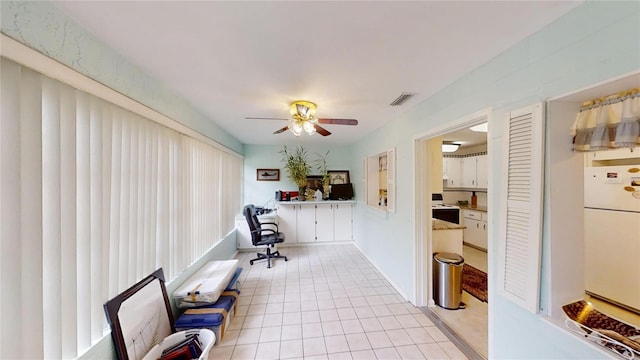 interior space featuring ceiling fan and light tile floors