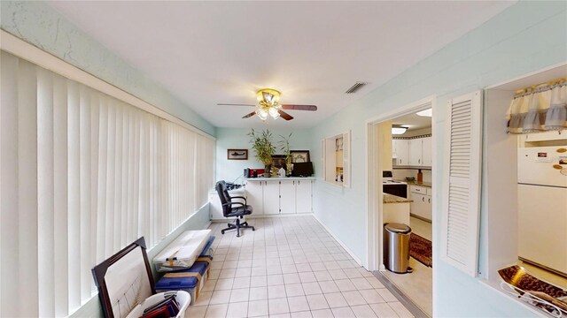 office space with visible vents, ceiling fan, and light tile patterned floors